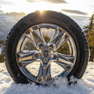 Goodyear WinterCommand tires on a snowy landscape at sunset